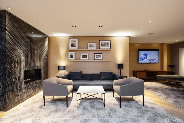 living room with light hardwood / wood-style floors and a large fireplace