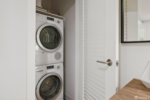 washroom with stacked washer / dryer