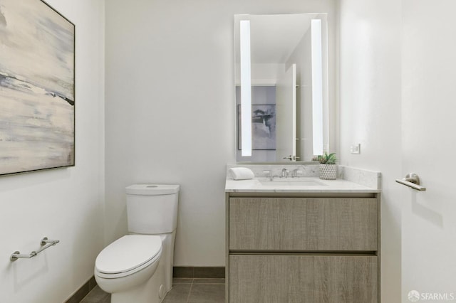 bathroom with tile patterned flooring, vanity, and toilet