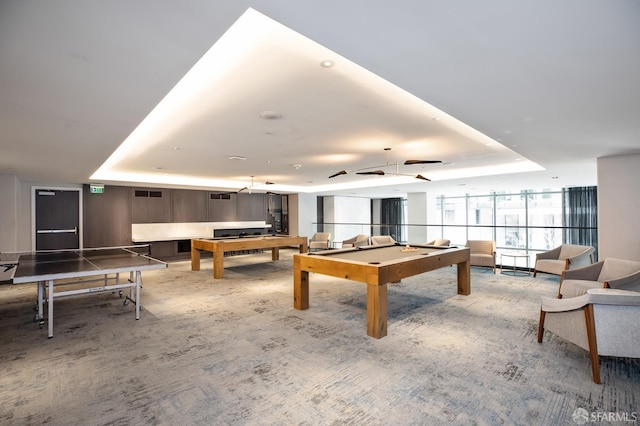 recreation room with carpet floors, billiards, and a raised ceiling