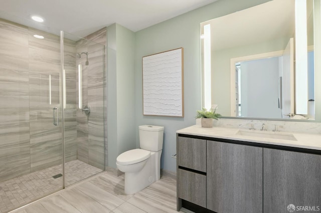 bathroom featuring walk in shower, vanity, and toilet