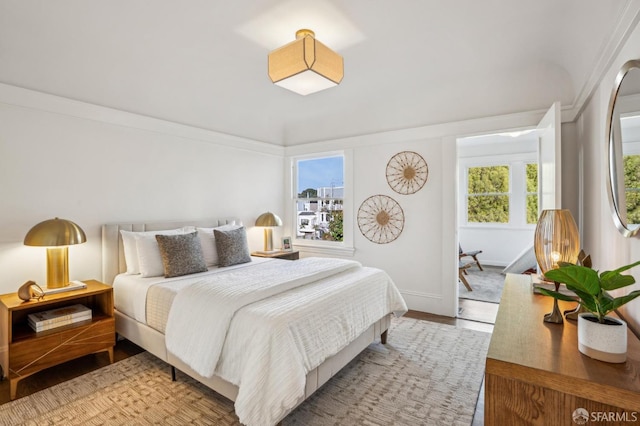 bedroom with baseboards and wood finished floors