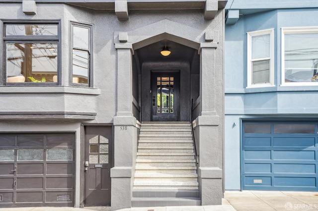 doorway to property with a garage