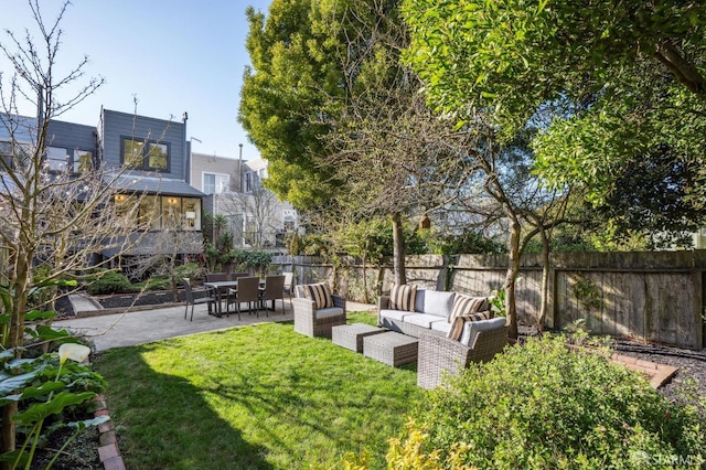 view of yard featuring a patio, outdoor lounge area, and a fenced backyard