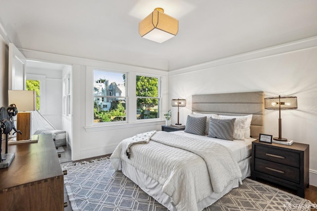 bedroom with baseboards and wood finished floors