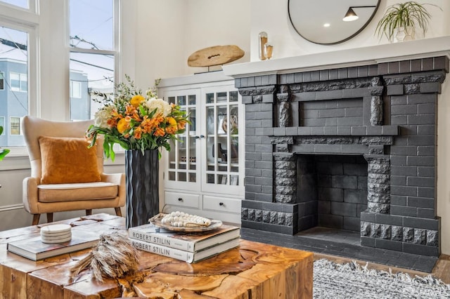 living area with a brick fireplace