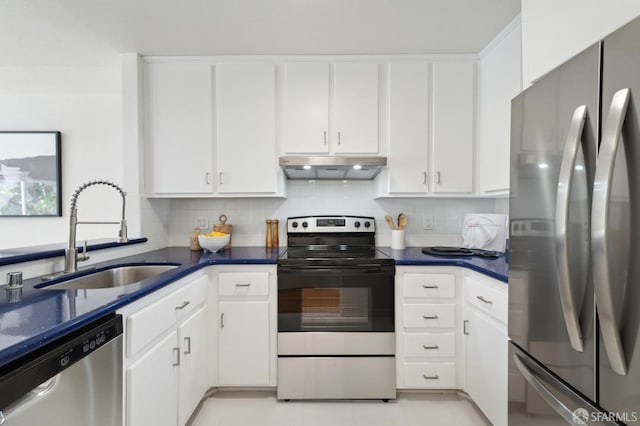 kitchen with sink, white cabinetry, backsplash, and stainless steel appliances