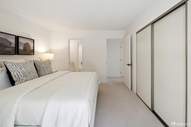 bedroom with light colored carpet and a closet