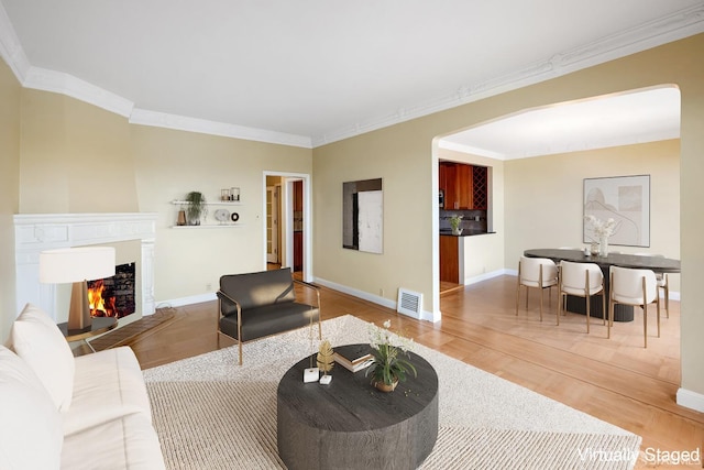 living room featuring hardwood / wood-style floors and crown molding