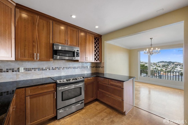 kitchen featuring appliances with stainless steel finishes, hanging light fixtures, backsplash, kitchen peninsula, and a chandelier