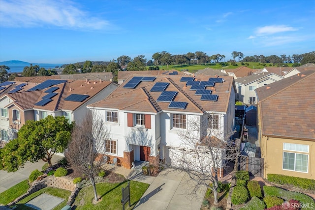 view of front of property featuring a garage and solar panels