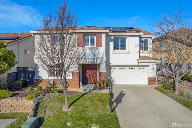 view of front of property with a garage, a front lawn, and solar panels