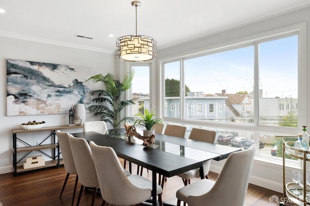 dining area featuring ornamental molding, dark wood finished floors, baseboards, and recessed lighting