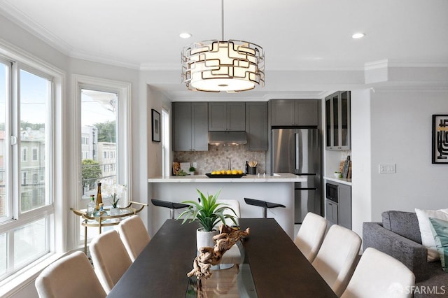 dining area with ornamental molding and recessed lighting