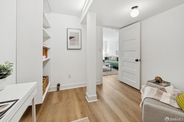 interior space featuring light wood finished floors and baseboards