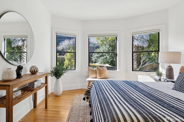 bedroom with light wood-type flooring and baseboards