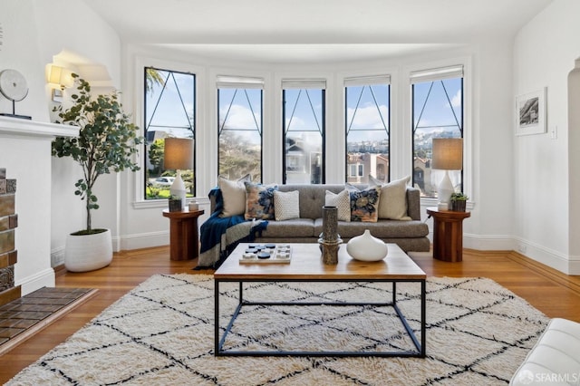 living area featuring baseboards and wood finished floors