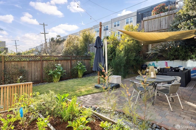 view of yard featuring outdoor dining area, a patio area, and a fenced backyard