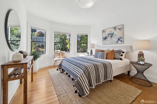 bedroom featuring baseboards and light wood-style floors