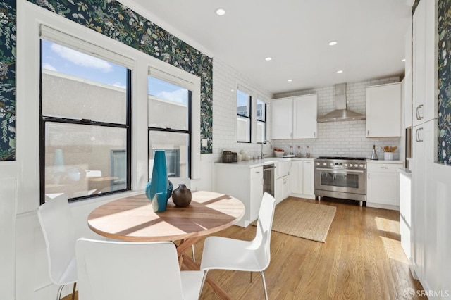 dining space with light wood-type flooring and recessed lighting