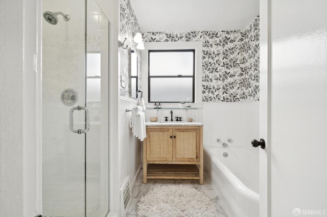 bathroom with a wainscoted wall, a garden tub, visible vents, a stall shower, and vanity