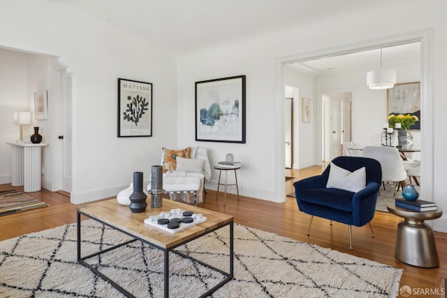 living area featuring baseboards and wood finished floors