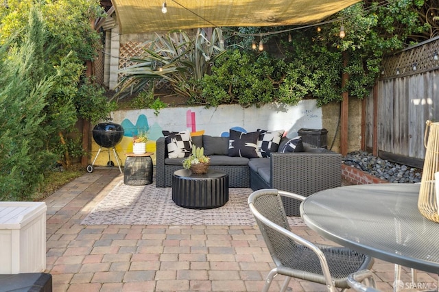 view of patio featuring outdoor dining area, a fenced backyard, and an outdoor living space