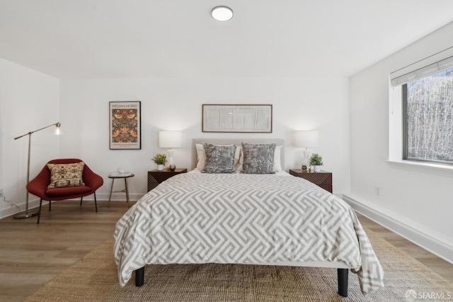 bedroom featuring baseboards and light wood-style floors