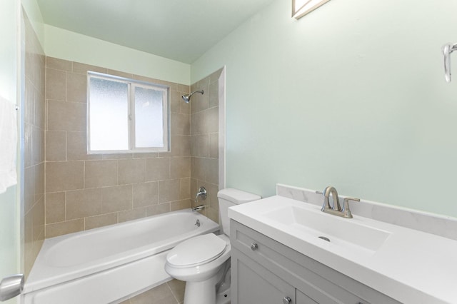 full bathroom featuring vanity, tile patterned flooring, tiled shower / bath combo, and toilet