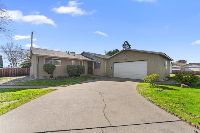 ranch-style home featuring a garage and a front yard