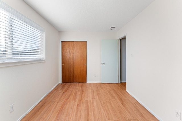 spare room with light hardwood / wood-style flooring