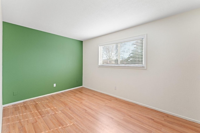 empty room with light hardwood / wood-style floors