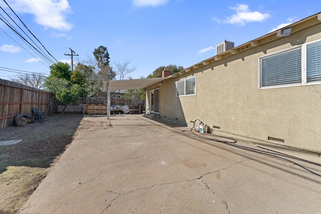 view of property exterior with cooling unit and a patio area