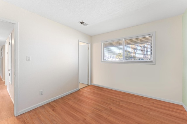 unfurnished bedroom featuring light hardwood / wood-style floors and a textured ceiling