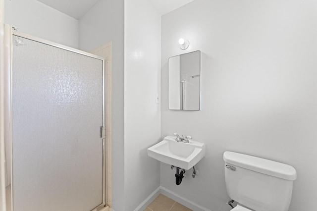 bathroom with sink, toilet, and a shower with door