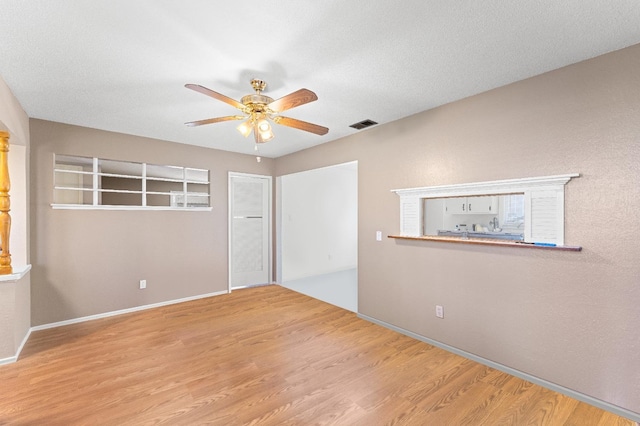 spare room featuring light hardwood / wood-style flooring and ceiling fan