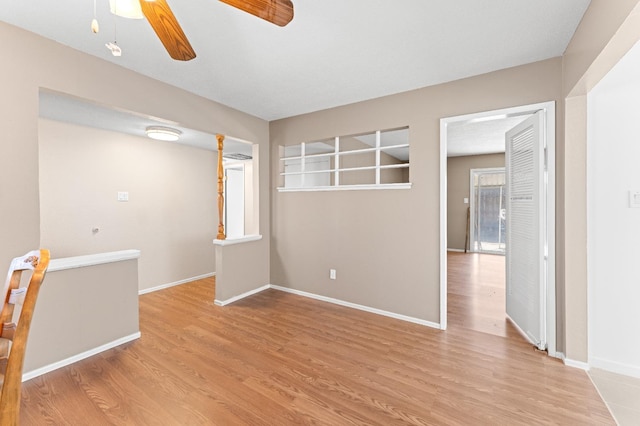 empty room with ceiling fan and light wood-type flooring