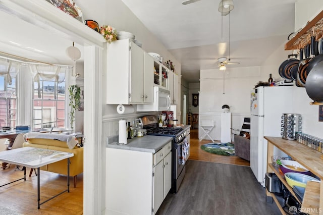 157-167 Vicksburg St, San Francisco, CA 94114 - kitchen with stainless steel gas range oven, ceiling fan, white microwave, and dark wood-style flooring