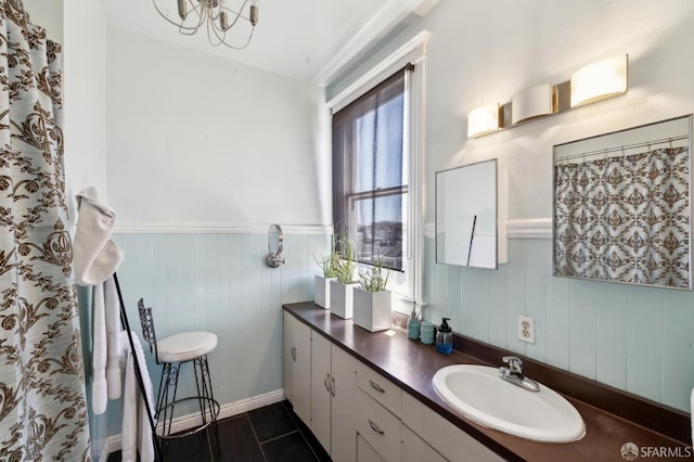 157-167 Vicksburg St, San Francisco, CA 94114 - bathroom featuring a wainscoted wall, vanity, tile patterned floors, a chandelier, and wood walls