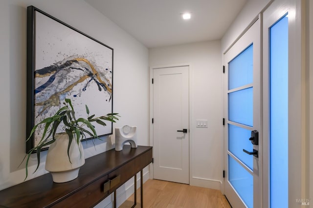 doorway with light wood-type flooring