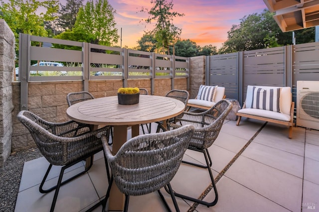view of patio / terrace with ac unit and fence