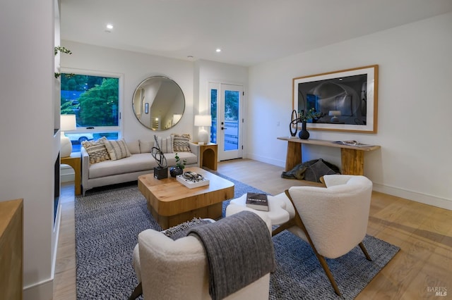 living area with baseboards, recessed lighting, and wood finished floors