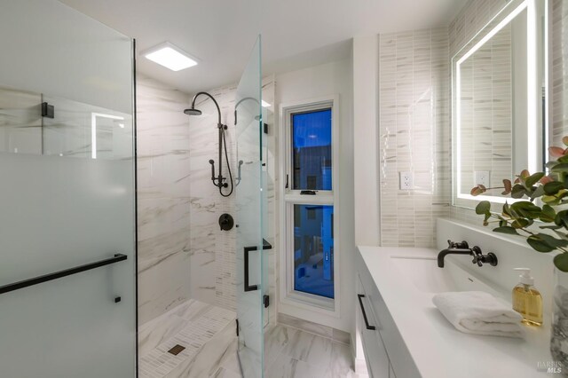 full bathroom featuring vanity, a marble finish shower, and marble finish floor
