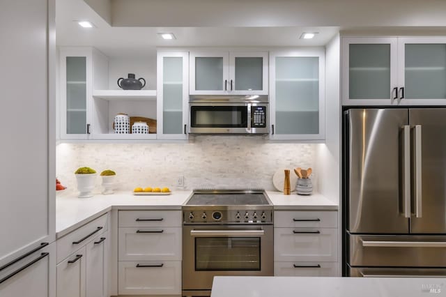 kitchen with white cabinetry, appliances with stainless steel finishes, and light countertops