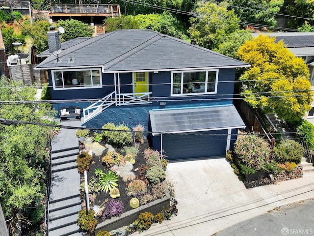 1751 Leimert Blvd, Oakland, CA 94602 - view of front facade featuring a garage, stairway, a chimney, concrete driveway, and a shingled roof