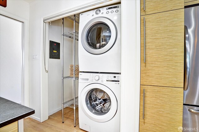 1751 Leimert Blvd, Oakland, CA 94602 - laundry room with estacked washer and dryer, wood finished floors, and electric panel