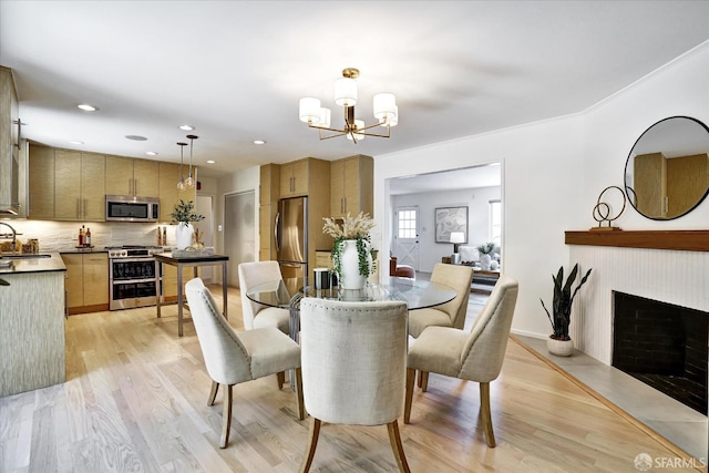 1751 Leimert Blvd, Oakland, CA 94602 - dining space with a chandelier, light wood-type flooring, a fireplace, and recessed lighting