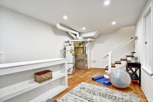 1751 Leimert Blvd, Oakland, CA 94602 - workout area featuring wood finished floors, strapped water heater, recessed lighting, and heating unit