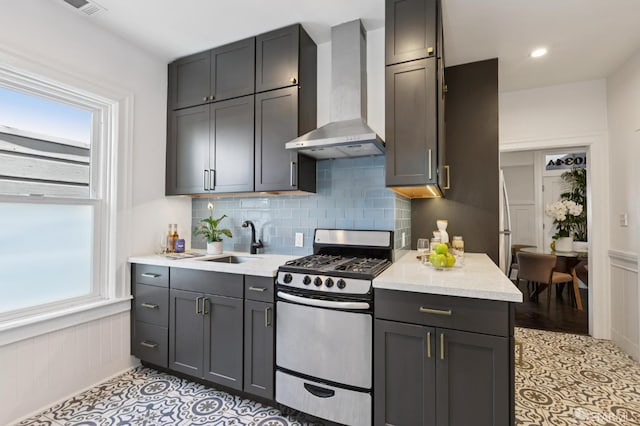 1034 Jackson St, San Francisco, CA 94133 - kitchen featuring stainless steel range with gas cooktop, wall chimney range hood, wainscoting, backsplash, and light tile patterned flooring