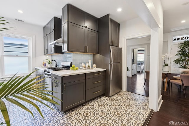 1034 Jackson St, San Francisco, CA 94133 - kitchen featuring stainless steel appliances, light countertops, healthy amount of natural light, tasteful backsplash, and recessed lighting